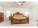 Spacious main bedroom featuring a carved wood bed, ceiling fan, and neutral decor at 1511 Womack Rd, Atlanta, GA 30338