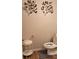 Charming bathroom features decorative metal leaf wall art for a stylish touch at 227 Happy Trl, Locust Grove, GA 30248