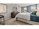 This main bedroom features neutral walls, plush carpet and a modern round mirror over the dresser at 3081 Greyton Dr, Buford, GA 30519