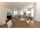 Open dining room with table and a view into the living area, with a ceiling fan and plenty of natural light at 542 Healy Dr # 52, Cumming, GA 30040