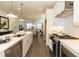 Modern kitchen featuring stainless steel appliances, a large island, and a view into the dining area at 542 Healy Dr # 52, Cumming, GA 30040