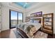 Bedroom with a view features wood floors, a tray ceiling, and a balcony at 2233 Peachtree Ne Rd # 1202, Atlanta, GA 30309