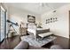 Inviting bedroom features a telescope, dark hardwood floors, and a seating area near a bright window at 2233 Peachtree Ne Rd # 1202, Atlanta, GA 30309