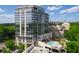 Modern high-rise condo with glass windows, green trees, and resort-style pool at 2233 Peachtree Ne Rd # 1202, Atlanta, GA 30309