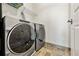 Modern laundry room with a side-by-side washer and dryer set, and tiled floors at 2233 Peachtree Ne Rd # 1202, Atlanta, GA 30309