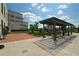 Exterior patio area with covered seating, lush landscaping, and elegant pavers at 2233 Peachtree Ne Rd # 1202, Atlanta, GA 30309