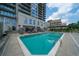 A large pristine pool surrounded by lounge chairs and lush landscaping offer a relaxing retreat at 2233 Peachtree Ne Rd # 1202, Atlanta, GA 30309