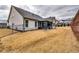 Expansive backyard with enclosed sunroom, featuring a wrought iron fence and lush, dormant grass at 4750 Fields Bridge Rd, Cumming, GA 30028