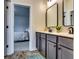 Bathroom with double vanity and framed mirrors that leads into a bedroom at 4750 Fields Bridge Rd, Cumming, GA 30028