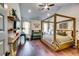 Spacious bedroom featuring a stylish four-poster bed, hardwood floors, and plenty of natural light at 4750 Fields Bridge Rd, Cumming, GA 30028