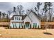 Beautiful white brick home with manicured landscaping and inviting blue front door at 4750 Fields Bridge Rd, Cumming, GA 30028