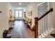 Hallway featuring gorgeous hardwood flooring, bench, and white trim at 4750 Fields Bridge Rd, Cumming, GA 30028