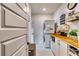 Well-organized laundry room with stacked washer and dryer, custom cabinets, and butcher block countertop at 4750 Fields Bridge Rd, Cumming, GA 30028