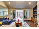 Bright living room featuring a modern blue sofa and seamless access to a sunroom, great for entertaining at 4750 Fields Bridge Rd, Cumming, GA 30028