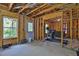 Unfinished basement with exposed framing, a window, and exercise equipment at 48 Scenic Ovlk, Acworth, GA 30101