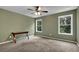 Spacious bedroom featuring two windows with views of the wooded surroundings, neutral carpeting, and a desk at 48 Scenic Ovlk, Acworth, GA 30101