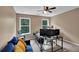 Bedroom features neutral carpet, a ceiling fan, and a blue sofa beneath two windows at 48 Scenic Ovlk, Acworth, GA 30101