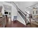 Inviting foyer with hardwood floors, a staircase with carpet and iron railing, and views into the living spaces at 48 Scenic Ovlk, Acworth, GA 30101