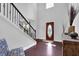 Bright foyer featuring a staircase, wood floors, and a decorative front door at 48 Scenic Ovlk, Acworth, GA 30101