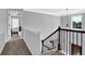 Upstairs hallway with iron railing, a view to the foyer and a glimpse of the carpeted bedrooms at 48 Scenic Ovlk, Acworth, GA 30101