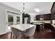 Bright kitchen with dark wood cabinets, stainless steel appliances, and a center island with deck access at 48 Scenic Ovlk, Acworth, GA 30101