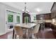 A modern kitchen area features a marble top table with seating and stainless steel appliances at 48 Scenic Ovlk, Acworth, GA 30101