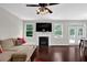 Cozy living room with a fireplace, large sectional sofa, and a view of the backyard at 48 Scenic Ovlk, Acworth, GA 30101