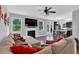 Cozy living room with a fireplace, large sectional sofa, and a view of the backyard at 48 Scenic Ovlk, Acworth, GA 30101