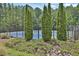 Community tennis courts with a privacy fence surrounded by trees and landscaping at 48 Scenic Ovlk, Acworth, GA 30101