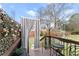 Inviting back deck features privacy curtains and outdoor seating, perfect for relaxing and enjoying the backyard view at 1164 Sandtown Sw Rd, Marietta, GA 30008