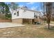 Rear exterior view showcasing a basement garage, stairs to the rear entrance, and a small yard at 1164 Sandtown Sw Rd, Marietta, GA 30008