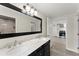 Stylish bathroom featuring dual sinks, a marble countertop, a large mirror, and stainless steel fixtures at 1164 Sandtown Sw Rd, Marietta, GA 30008