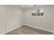 Clean, simple bedroom with hardwood floors, neutral walls, and a bright window at 1164 Sandtown Sw Rd, Marietta, GA 30008