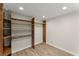 Spacious walk-in closet with custom wood shelving and ample storage space at 1164 Sandtown Sw Rd, Marietta, GA 30008