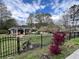 View of stone-clad cottage with fenced front yard and landscaped garden at 1164 Sandtown Sw Rd, Marietta, GA 30008