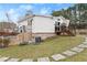 Exterior of the house featuring a walkout basement, a well-maintained lawn, and a backyard patio at 1164 Sandtown Sw Rd, Marietta, GA 30008