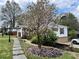 Landscaped yard with blooming magnolia tree and stone pathway to the home at 1164 Sandtown Sw Rd, Marietta, GA 30008