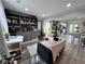 Open-concept living room with built-in shelving and adjacent modern kitchen at 1164 Sandtown Sw Rd, Marietta, GA 30008