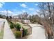 Street view of property with a fenced yard, long driveway, and landscaping at 1164 Sandtown Sw Rd, Marietta, GA 30008