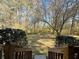 View from back porch steps showcasing lush backyard with mature trees and landscaping at 1395 W Booth Road Sw Ext, Marietta, GA 30008