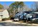 Exterior view of home featuring a private driveway and manicured landscaping at 1395 W Booth Road Sw Ext, Marietta, GA 30008