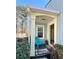 Inviting front porch with a teal chair, a 'Welcome' mat, and a potted plant by the entrance at 1395 W Booth Road Sw Ext, Marietta, GA 30008