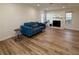 Bright living room with wood floors, a cozy blue sofa, and a fireplace with a white mantle at 1395 W Booth Road Sw Ext, Marietta, GA 30008