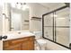 Bathroom with vanity, toilet, and tiled tub with glass doors at 158 Ashwood Drive Dr, Dallas, GA 30157