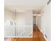 Upstairs hallway featuring hardwood floors and natural light from the half round window at 158 Ashwood Drive Dr, Dallas, GA 30157