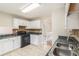 Functional kitchen featuring white cabinets, black appliances, and durable countertops at 158 Ashwood Drive Dr, Dallas, GA 30157