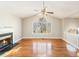 Bright living room with hardwood floors, fireplace, ceiling fan, and a large arched window at 158 Ashwood Drive Dr, Dallas, GA 30157