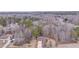 Distant aerial view of home nestled in a wooded setting with a long driveway at 60 Kyler Way Way, Dallas, GA 30157