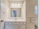 Bright bathroom vanity with white cabinets, sink, and large mirror complemented by storage cabinets at 60 Kyler Way Way, Dallas, GA 30157