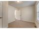 Bedroom with white walls and neutral carpet, window, and door leading to wood floors at 60 Kyler Way Way, Dallas, GA 30157